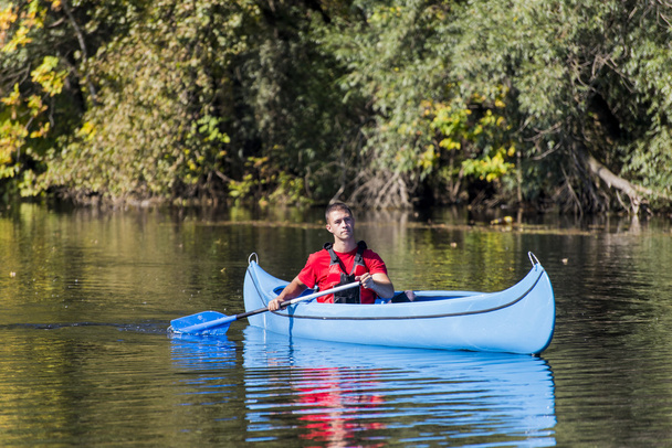 Young man in canoe - Photo, Image
