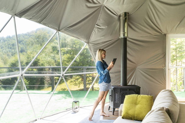 woman with tablet in dome tent. - Photo, Image