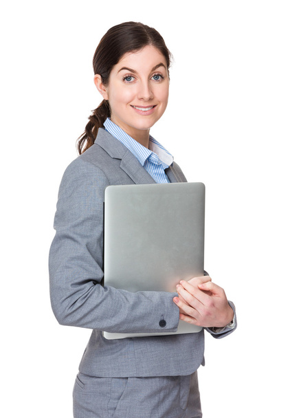 Caucasian young businesswoman in grey suit - Foto, imagen