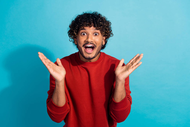 Photo of amazed latin guy first time seeing black friday proposition hot sale deal in all stores isolated on aquamarine color background. - Foto, imagen