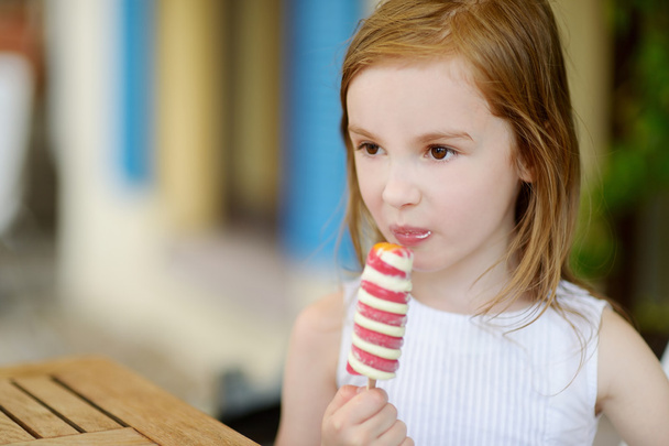 дівчина їсть морозиво на відкритому повітрі
 - Фото, зображення