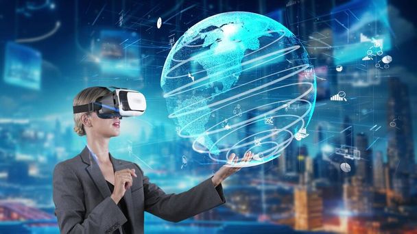Woman looking finance big data dynamic rotating dynamic world screen by VR future global market innovation interface digital infographic network technology virtual hologram at building. Contraption. - Photo, Image