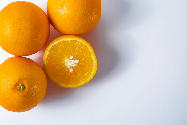 Oranges on a white background with copy space for your text. Top view - Photo, Image