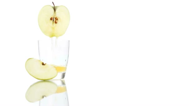 Jablečné šťávy nalije do skleněné izolovaných na bílém pozadí - Záběry, video