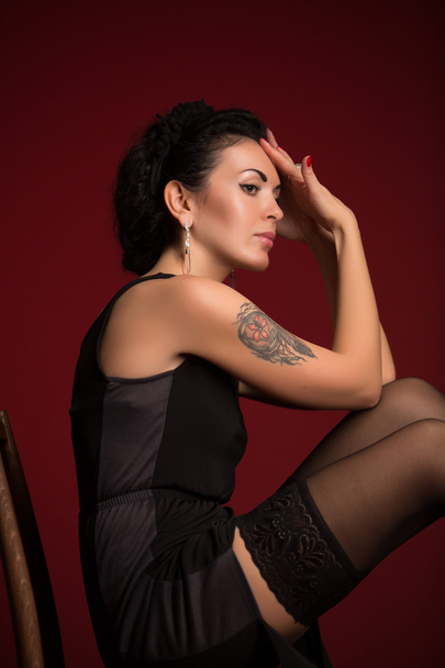 Studio portrait of a sexy brunette in black stockings - Fotoğraf, Görsel