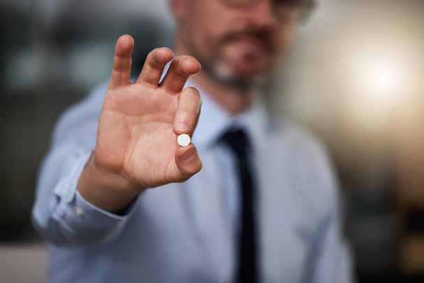 Business, man and pill in hand in office for headache or stress relief, vitamins and supplements for energy. Person, pain killer and anxiety medication or booster for productivity or focus at work - Photo, Image