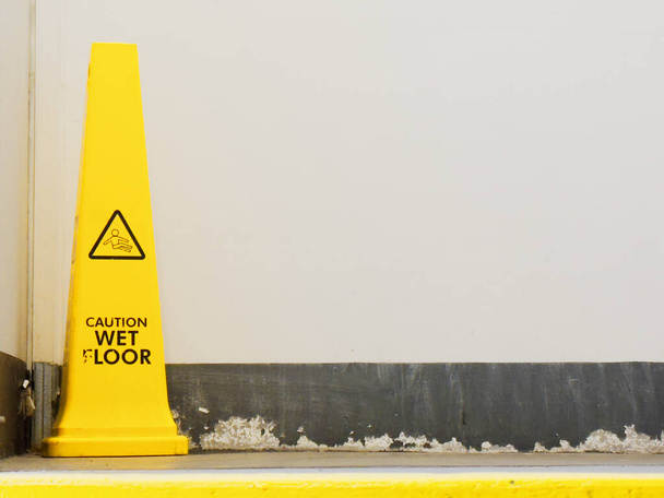 Caution wet floor cone safety notice at public stair UK - Photo, Image