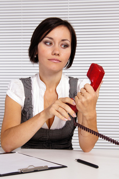 Adult girl with telephone - 写真・画像