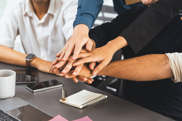 Group of diverse office worker join hand together in office room symbolize business synergy and strong productive teamwork in workplace. Cooperation and unity between business employee. Prudent - Photo, Image