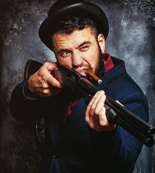 Powerful businessman with a gun - Фото, изображение