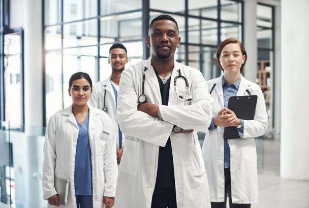 Diversity, doctors and portrait with pride in hospital for collaboration with healthcare, help and advice. Black man, global staff and teamwork in clinic with stethoscope, medical job and confidence. - Photo, Image
