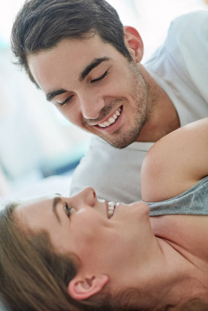 Couple, bedroom and happiness in closeup and together for bonding, love or happy for relationship. Man, woman and smile for relax in hotel with trust, vacation or holiday with partner in Paris Europe. - Photo, Image