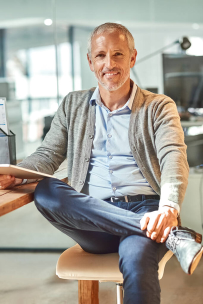 Mature man, tablet and portrait in office, chief executive officer and check email at desk. Person, entrepreneur and owner of finance firm at workplace, accounting app and website for economy update. - Photo, Image