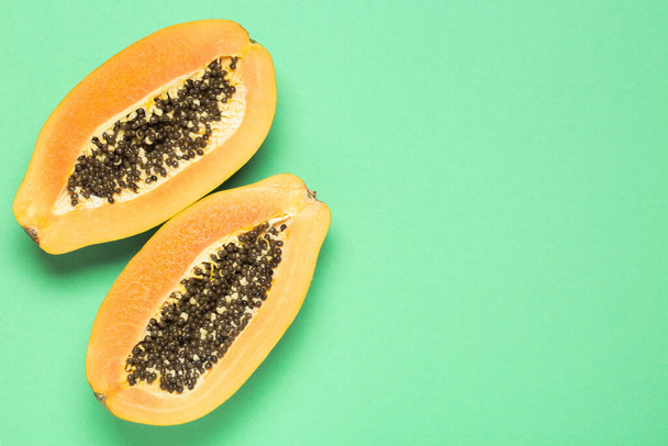 Papaya on a green background, top view, copy space - Photo, Image