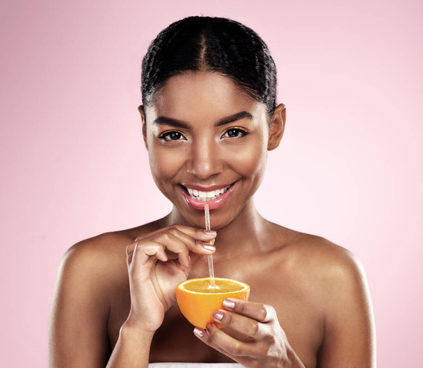 Woman, drink and portrait with orange juice in studio for vitamin c benefits in skincare on background. Citrus, fruit and smoothie for healthy nutrition, diet and natural beauty or organic cosmetics. - Photo, Image