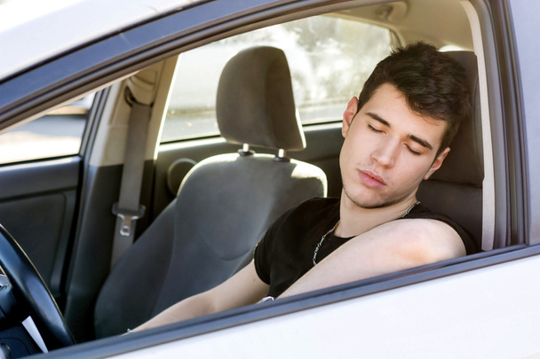 Handsome Young Man sleeping in a Car - Photo, image