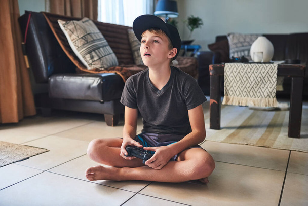 Home, television and kid relax with video games on vacation or gaming on holiday in lounge. Boy, house and child playing online rpg battle or watch competition in esports with subscription or app. - Photo, Image