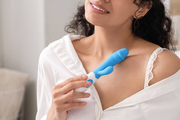 Young woman with vibrator in bedroom, closeup - Fotoğraf, Görsel