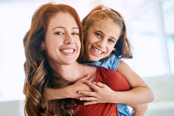 Mom, girl and happy in portrait with piggyback for love, support and appreciation on mothers day. Woman, kid and happiness in living room with smile for trust, gratitude and family bonding at home. - Photo, Image