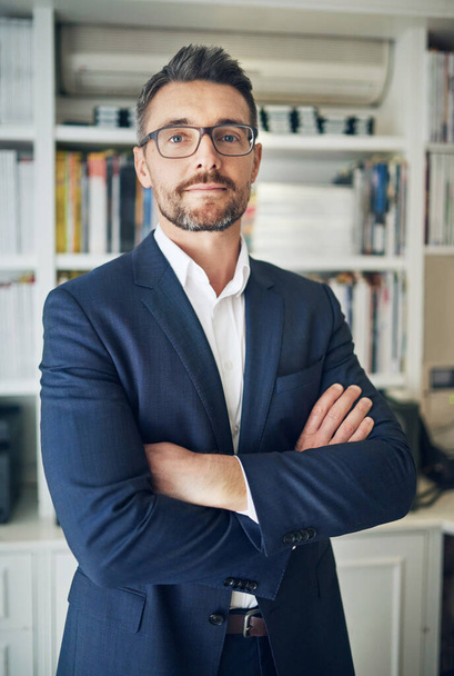 Portrait, confidence and business man in office for career or job in UK at workplace. Glasses, arms crossed and face of professional attorney, entrepreneur and serious corporate employee in suit. - Photo, Image