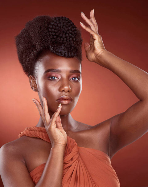 Makeup, skincare and beauty portrait of black woman in studio for wellness or aesthetic isolated on a red background. Face, fashion and cosmetics of serious African model for shine, glow and style. - Photo, Image