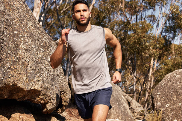 Man, running and athlete on outdoor mountain, cardio sports and marathon training for practice. Male person, active and trail for wellness challenge, nature and exercise for health and sportswear. - Photo, Image