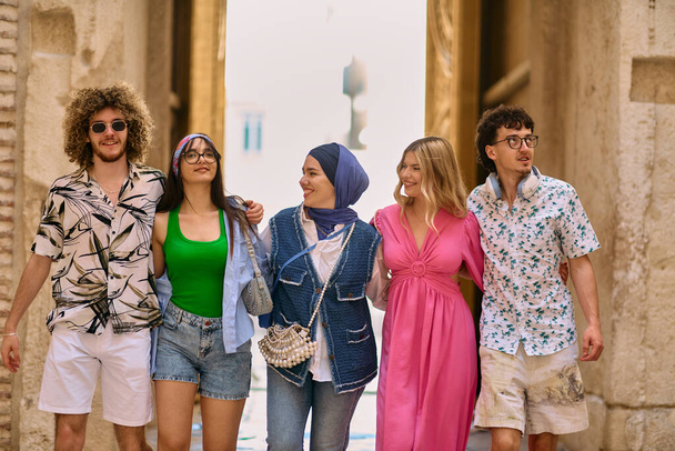 A diverse group of tourists, dressed in summer attire, strolls through the tourist city with wide smiles, enjoying their sightseeing adventure.  - Photo, Image