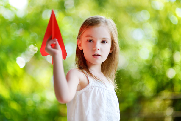 girl holding a paper plane - Foto, immagini