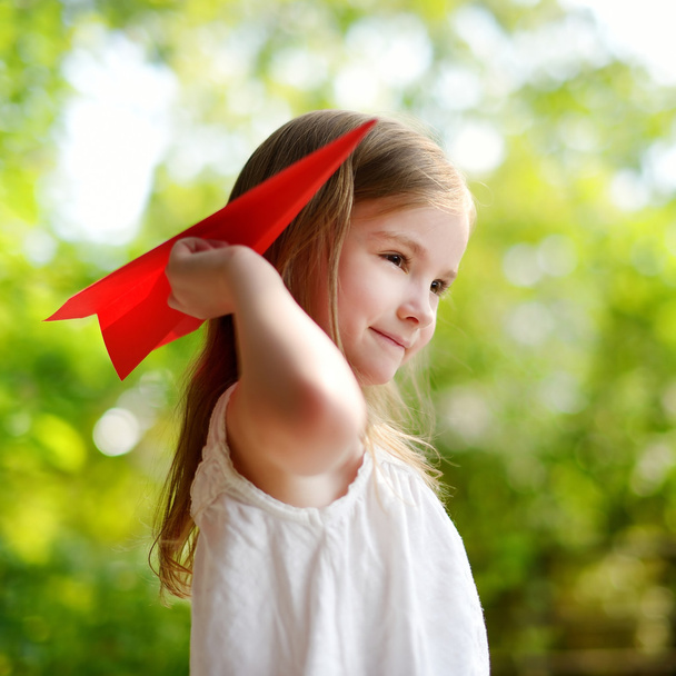 girl holding a paper plane - Valokuva, kuva