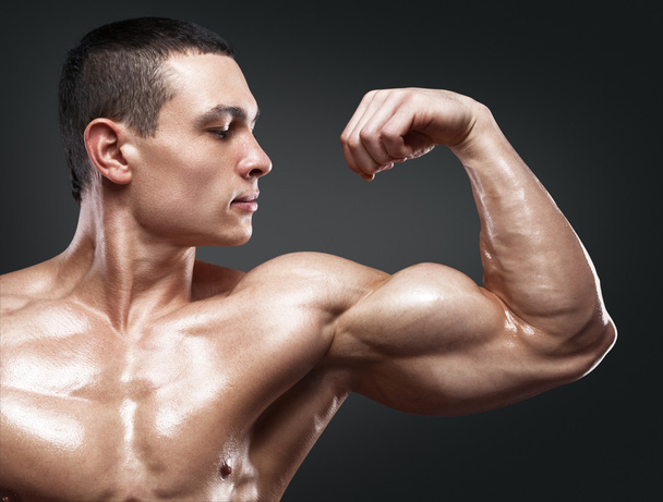 Strong and handsome young bodybuilder demonstrate his muscles an - Foto, immagini