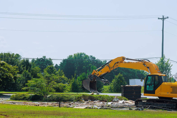 An excavator loads construction concrete waste into dump container on construction site - Photo, Image