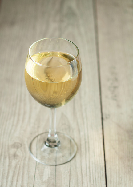 white wine in glass on vintage background - Fotó, kép