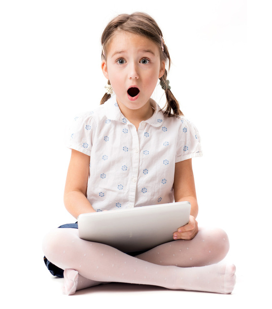 Portrait of surprise young girl with tablet - Photo, Image