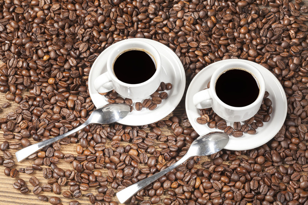 Two espressos among coffee beans. - Photo, Image
