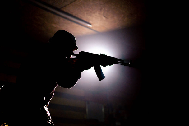 a military tactical strategy aiming NATO rifle contrast light back light silhouette - Photo, Image