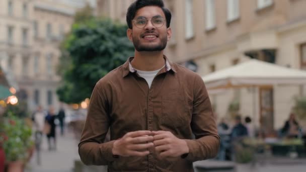 Boldog mosolygós lelkes indiai arab etnikai férfi férfi férfi üzletember néz kamera pozitív győztes örvendezzen győzelem ünnepli nyerni szerencse diadal mutatja hüvelykujját fel gesztus szabadban város utcáján - Felvétel, videó