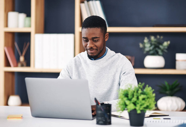 Black man, smile and laptop in office for web design, digital project or social media communication. Business person, internet or working on tech typing for connectivity, online search or blog post. - Photo, Image
