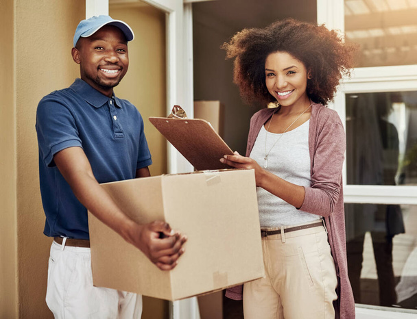African delivery man, woman and sign with portrait for package, stock and documents at front door. People, courier and writing with invoice, clipboard and box with customer satisfaction at apartment. - Photo, Image