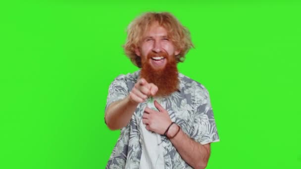 Amused happy man pointing finger to camera, laughing out loud, taunting making fun of ridiculous appearance, funny joke anecdote. Handsome redhead guy isolated alone on green chroma key background - Footage, Video