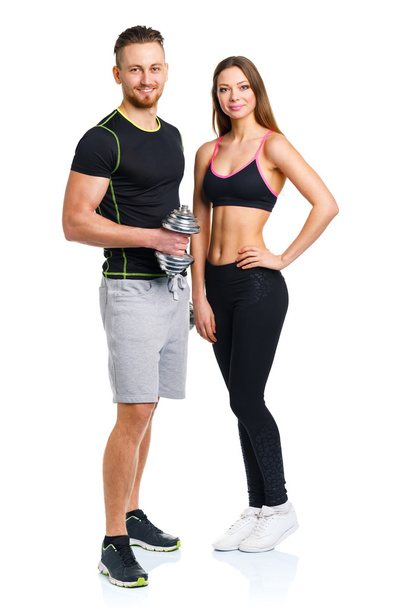 Couple sportif - homme et femme avec haltères sur le blanc
 - Photo, image