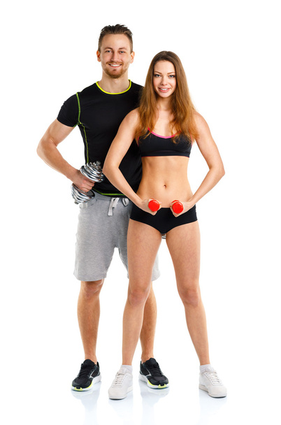 Pareja deportiva - hombre y mujer con mancuernas en el blanco
 - Foto, imagen
