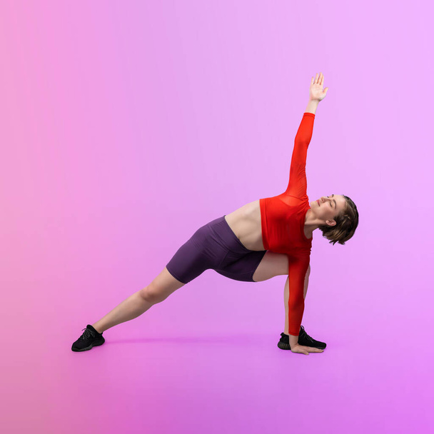 Full body length gaiety shot athletic and sporty woman doing healthy and meditative yoga exercise workout posture on isolated background. Healthy active and body care lifestyle - Photo, Image