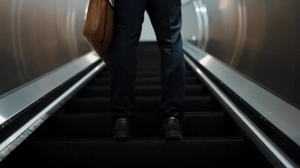 Closeup of smart professional business man leg standing at escalators. Skilled project manager getting promotion, increasing skill, upgrading, getting new position. Center. Focus on leg. Exultant. - Footage, Video