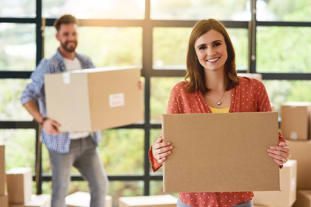 Moving, boxes and excited couple in portrait with happiness for property, investment and opportunity. Transport, relocation and woman with package in real estate or apartment to rent with help. - Photo, Image