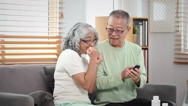 Zorgvuldige volwassen man controleert de bloedsuikerspiegel van zijn diabetische vrouw thuis. Ouderen zorgconcept. - Video