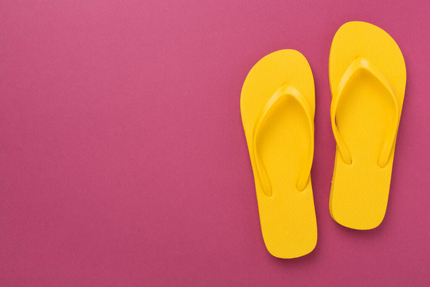Bright yellow flip-flops on color background, top view. Summer concept - Photo, Image