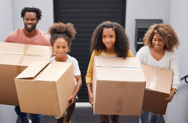 Happy, family and moving with boxes in house for real estate, walking or together or helping. Group, people and new home with investment or growth for children, welcome or property with mortgage. - Photo, Image