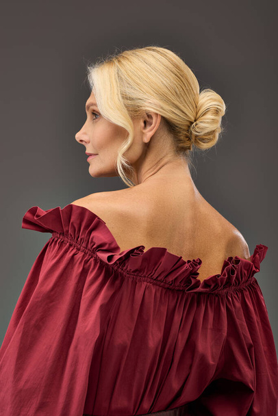 Mature woman in red blouse and high ponytail. - Photo, Image