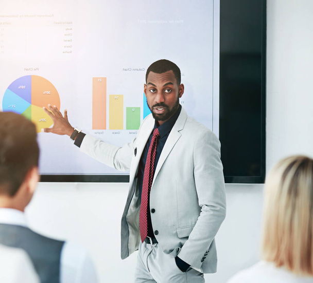 Businessman, coaching and chart with screen for presentation, meeting or corporate statistics at seminar. Black man, manager or speaker talking to employees on company revenue, growth or profit. - Photo, Image