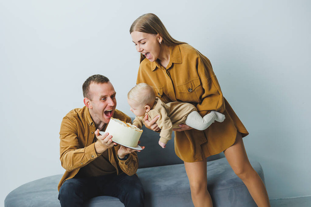 Young parents with a newborn baby, loving mother holding her little son in her arms, tender family moments, parenting concept. High quality photo - Photo, Image